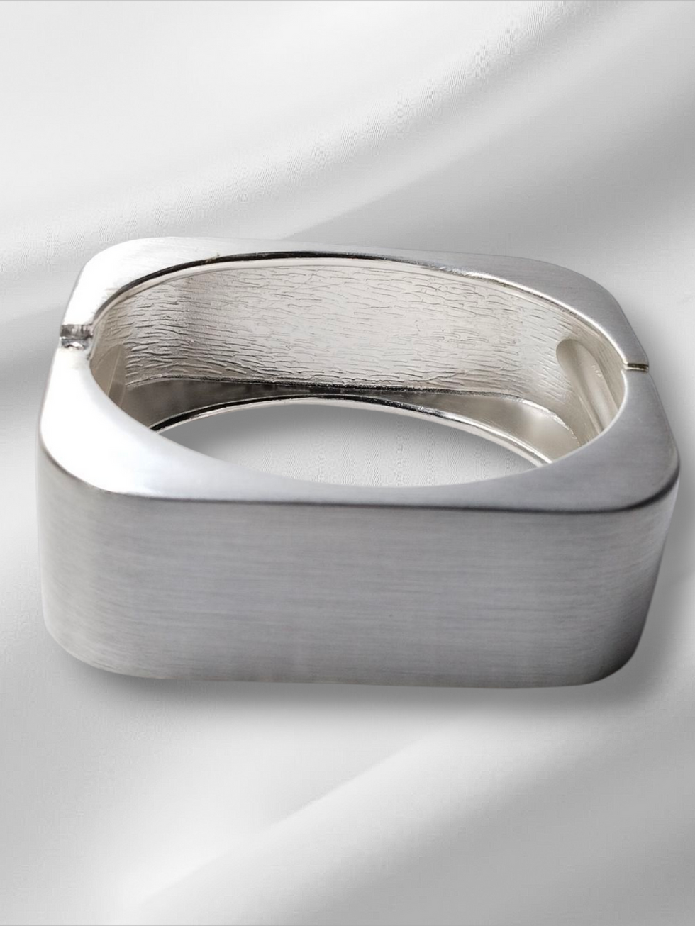 Square silver bracelet on white background, Lavish Jewellery.