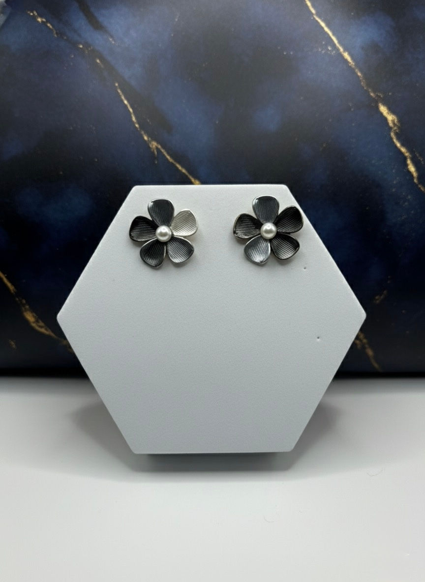 Flower stud earrings on white display with Lavish Jewellery background detail.