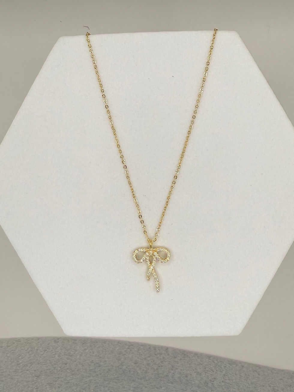 Gold necklace on white stand. Evil Eye Pendant Gold Polish Necklace. Lavish Jewellery