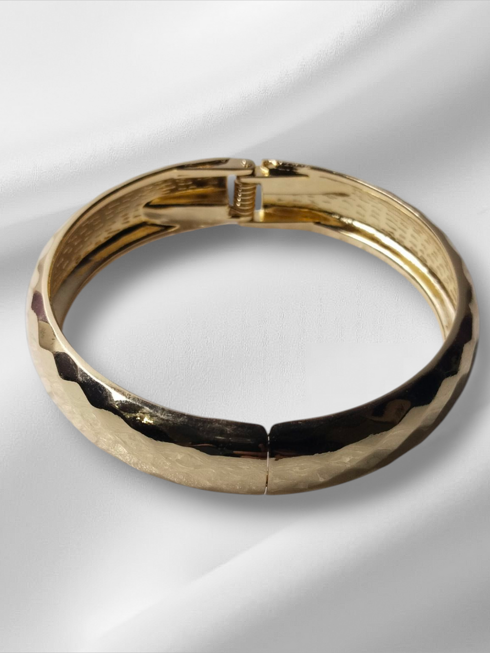 Gold bracelet on white silky fabric. Lavish Jewellery Zirconia Gold Colour Earring.