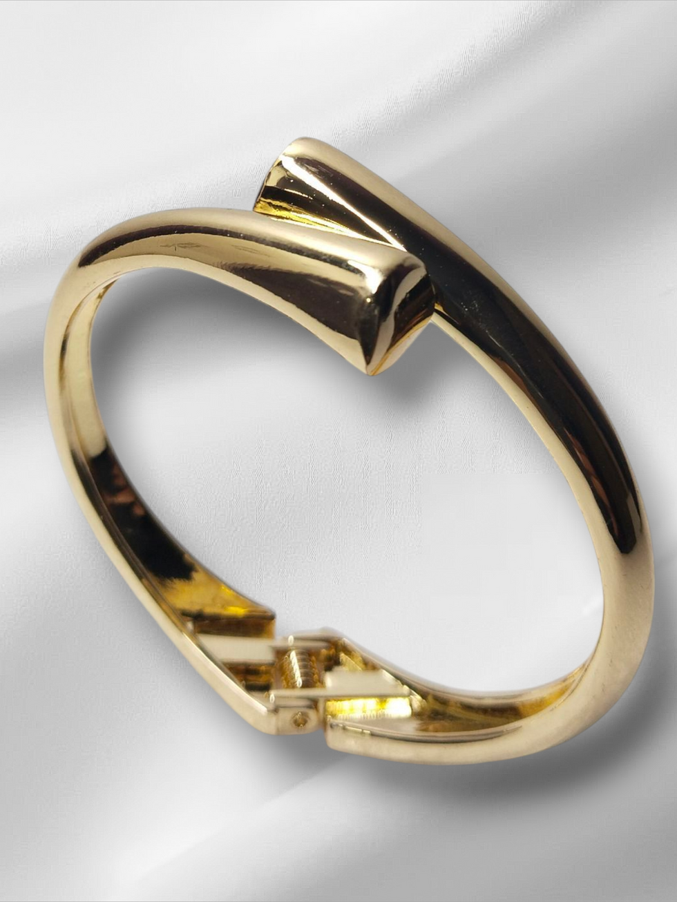 Golden bracelet on white satin, Lavish Jewellery, elegant and stylish design.