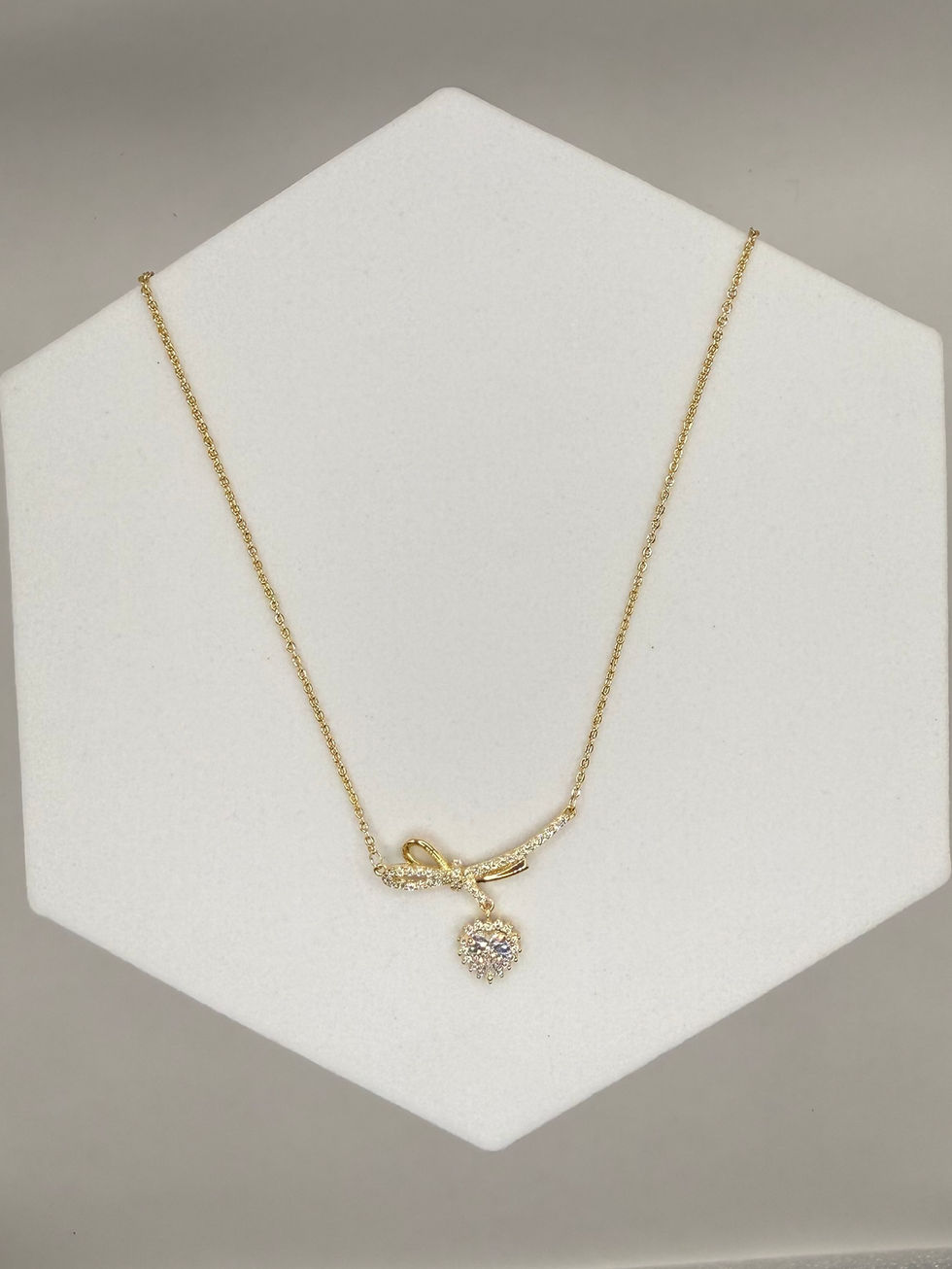 Elegant gold necklace with a diamond pendant on display showcasing Lavish Jewellery.