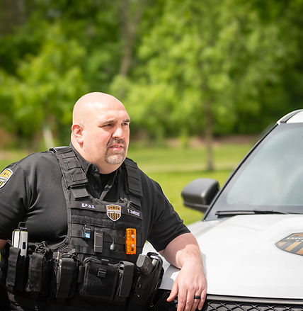 EPSS security officer waiting by a branded vehicle for secure client pickup