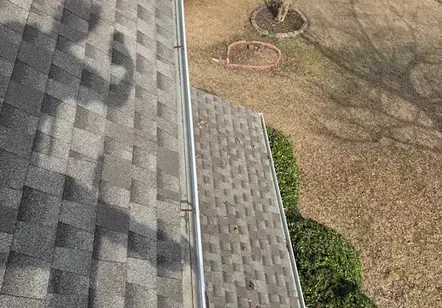 "Expert gutter cleaning and roof inspection service to ensure proper drainage for a home in Between, Georgia."