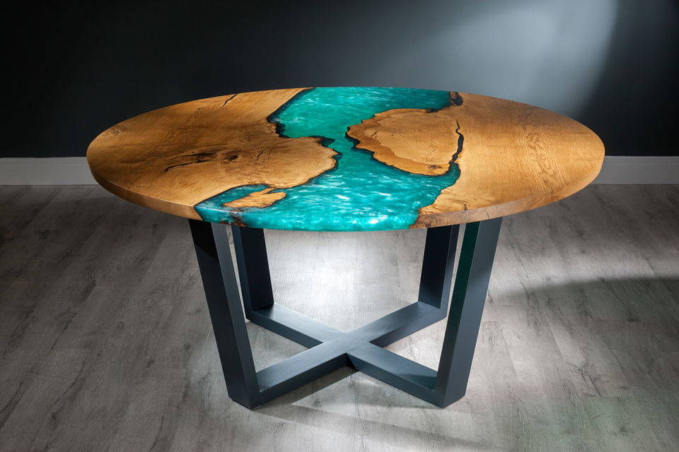 Round river dining table made from two planks of Scottish oak wood with sea-green coloured resin in between. The base of the table is made from grey painted wood.