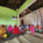 Group of women sitting on the floor in a room