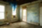 Room undergoing full renovation with stripped walls and exposed ceiling, illustrating renovation investment potential in 2025"