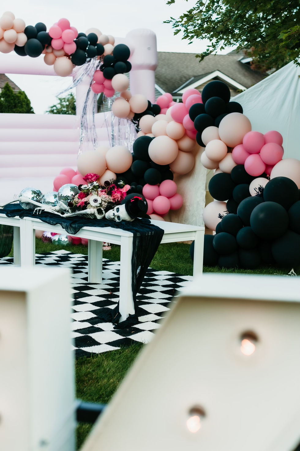PCE Halloween - skeleton floral installation with bounce house and balloon backdrop