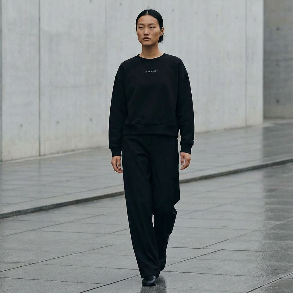 model wearing black organic cotton womens crew, black pants, minimal vibe urban