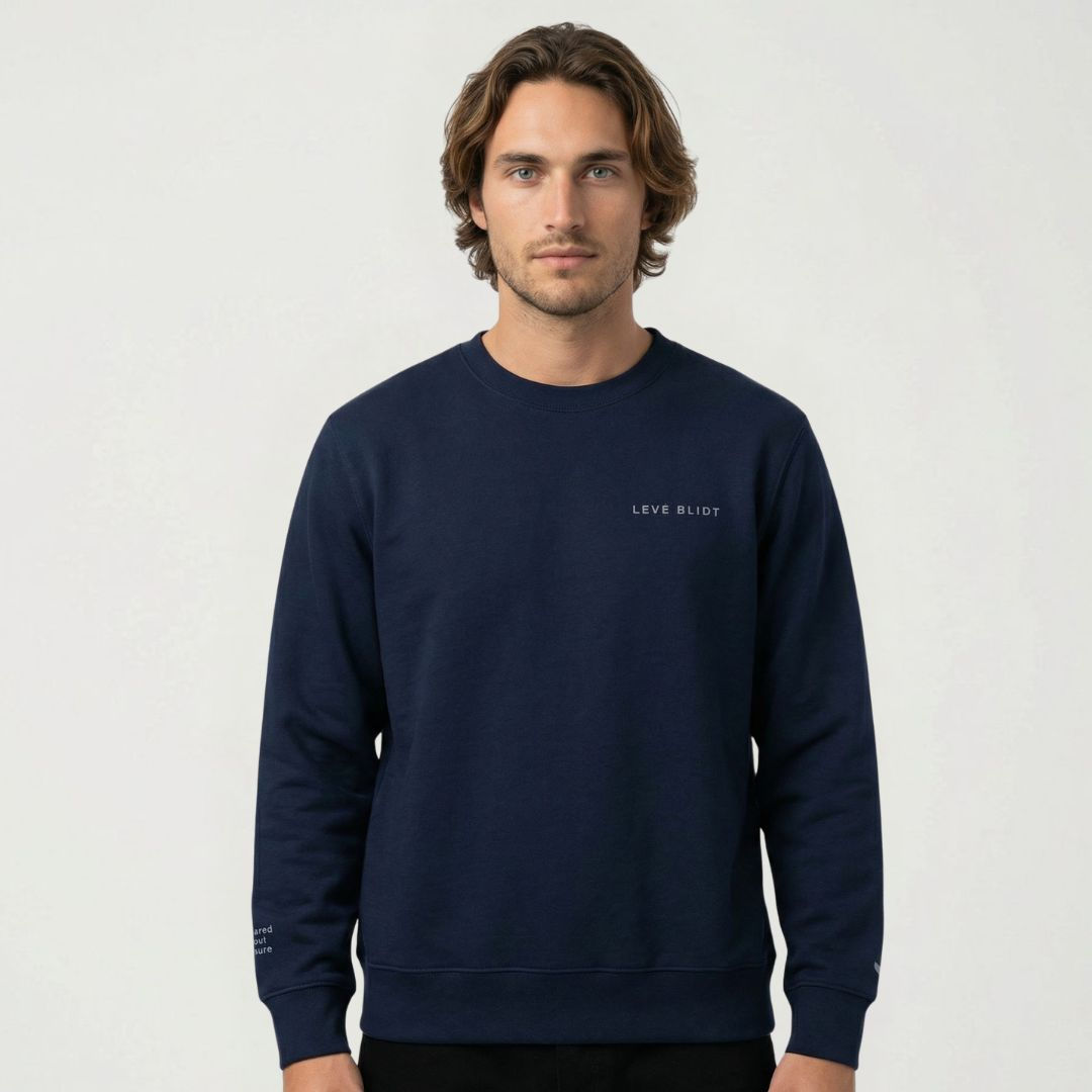 studio portrait of man wearing navy statement crew with subtle LEVE BLIDT grey embroidered on left chest