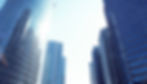 City skyline with buildings reflecting in water, representing commercial energy solutions for urban environments