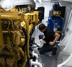 Engineer Nick Fuller checks fluids in Teresa Brusco’s all-Cat engine room.