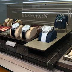 Elegant watches are inside a glass display