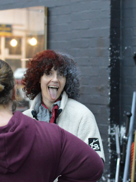 Dee with a client pulling a face