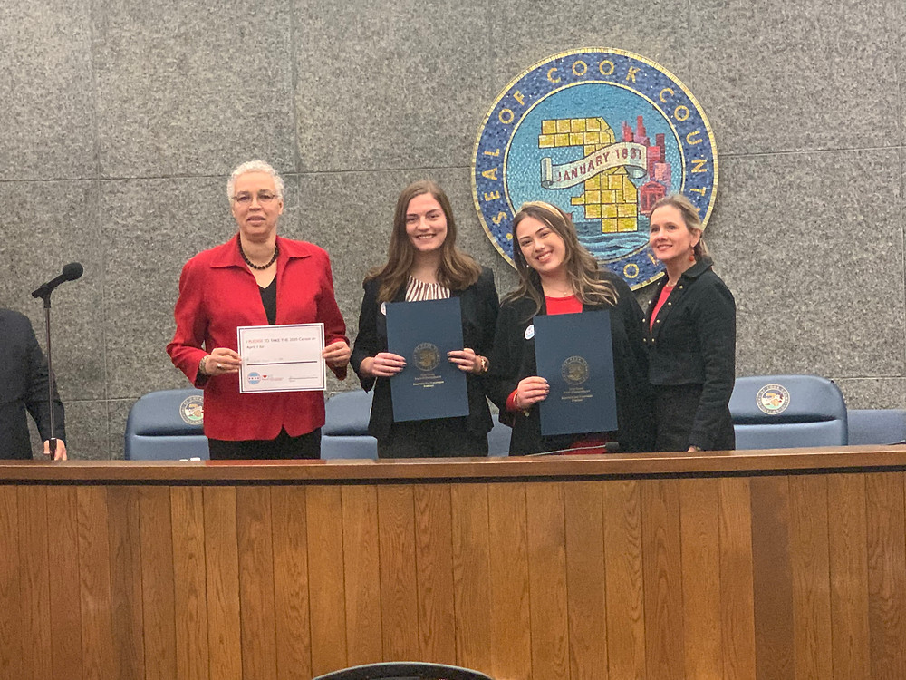President Toni Preckwinkle and Distrct 12 Commissioner Bridget Degnen recognize Natalie Rohman and Callie Boboc for Love Where You Count in an official resolution
