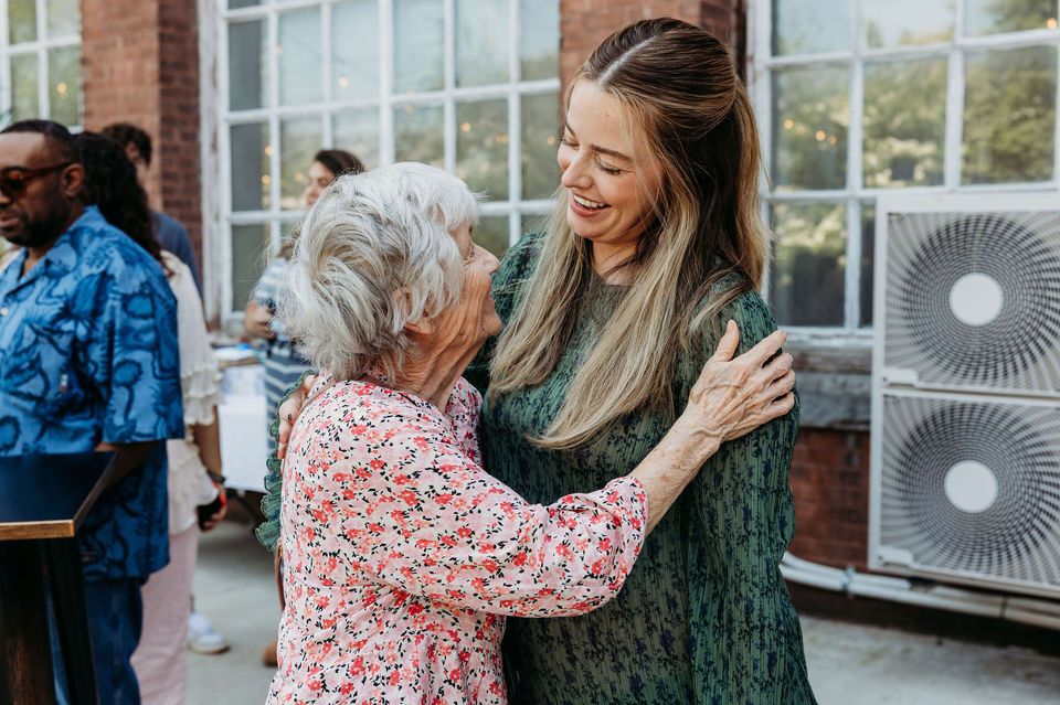 The baby shower celebrant talking with a relative on the courtyard