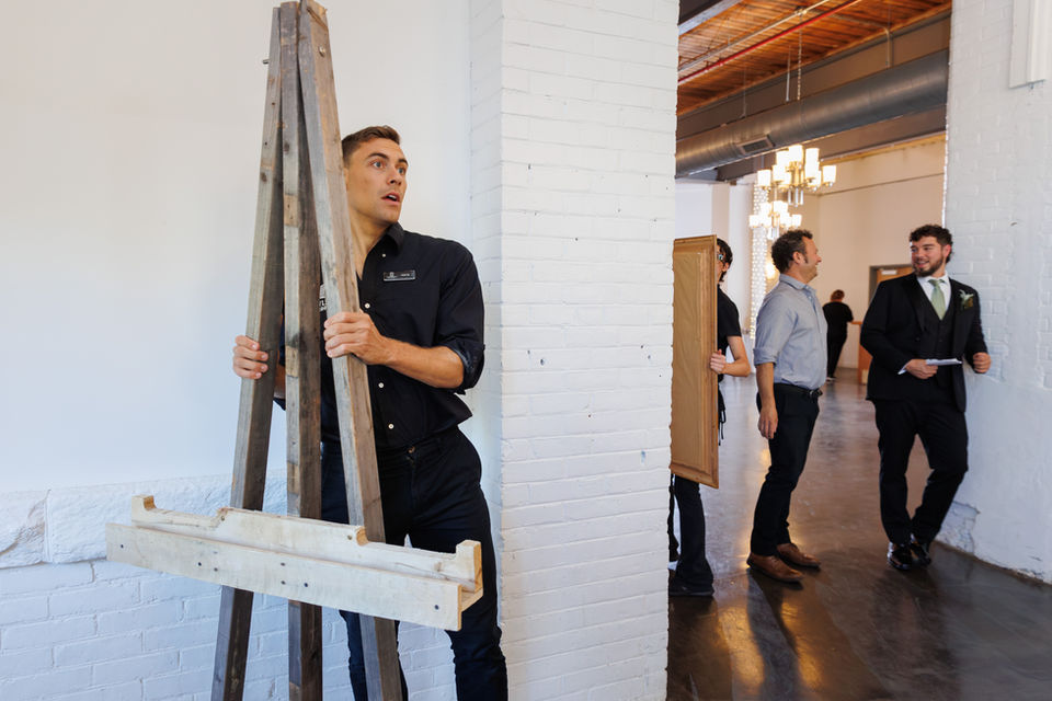 Staff person removing an easel from the event room.