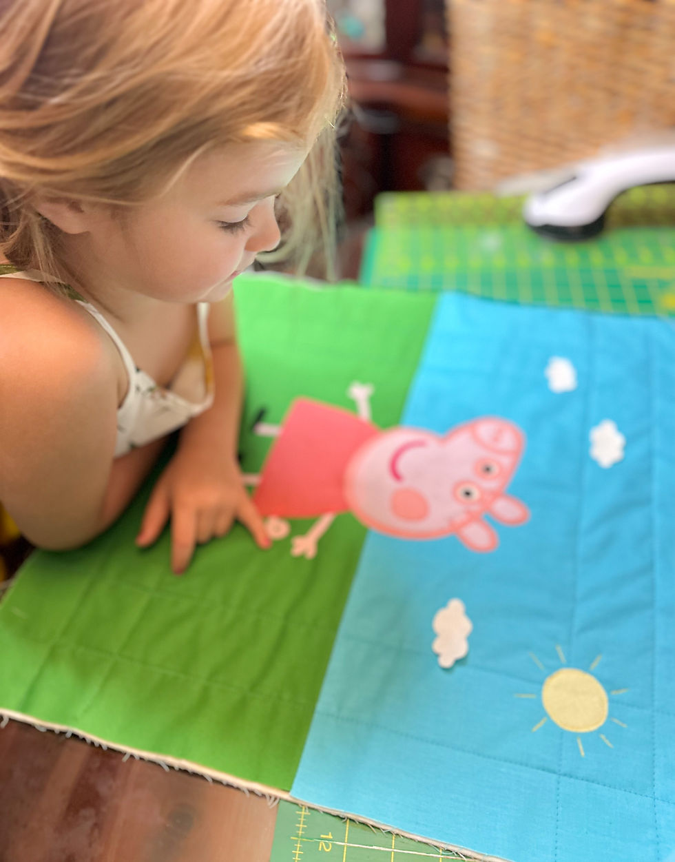 Thumbnail: Little girl looking at Peppa pillow in progress