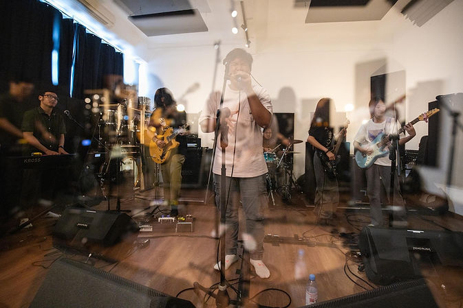blurred image of band jamming out at 4th Wall Studios Singapore studio nearby bishan