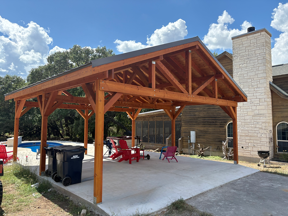 Large wood pavilion beside home on concrete backyard patio