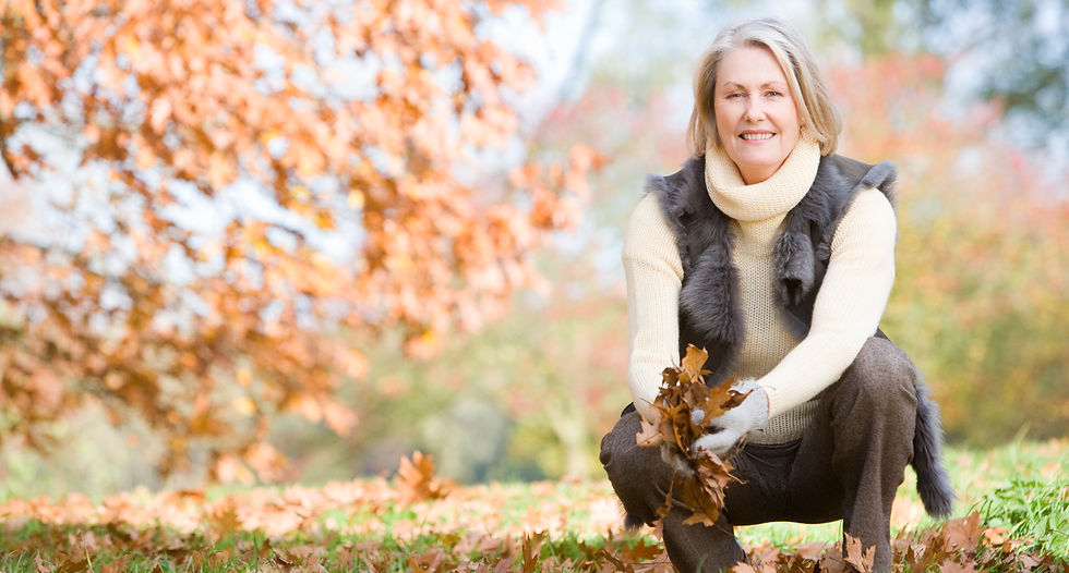 senior-woman-collecting-autumn-leaves-on-walk-SBI-301028059_edited.jpg