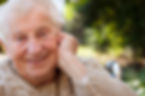 happy-senior-lady-in-wheelchair-smiling-outside-SBI-317477454.jpg