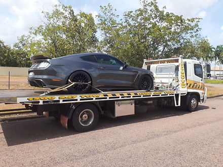 Motor vehicle being towed on tow truck