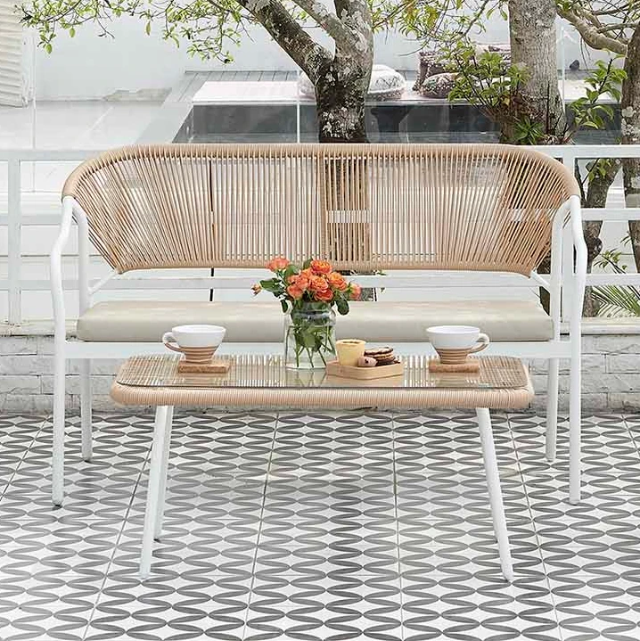 Sophie Rattan Patio Sofa and table with White Aluminum Frame Outdoor Scene