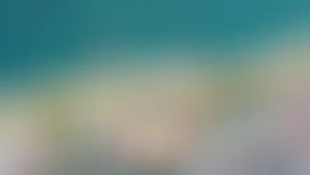 Аэрофотоснимок курортного комплекса Fame Residence Kemer & SPA 5* в Турции. Отель с несколькими бассейнами и зеленой территорией расположен непосредственно на берегу Средиземного моря. Видны пляжная зона с пирсами, основное здание с терракотовой крышей и прилегающие корпуса.