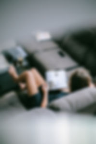 woman-sitting-on-sofa-while-reading-book