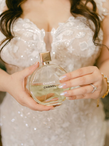Bride portrait shot holding a perfume bottle