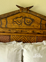 2 lions carved into wooden head board