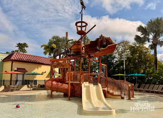 Kids splash area with pirate theming and water slide at Caribbean Beach