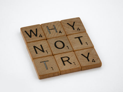 "why not try" written with Scrabble blocks