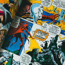 Open comic spread of Silver Surfer in action