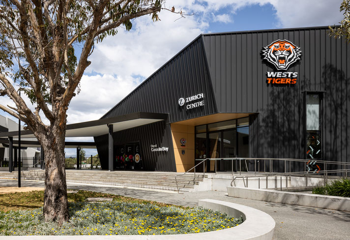 Urban public plaza with integrated seating and green areas.