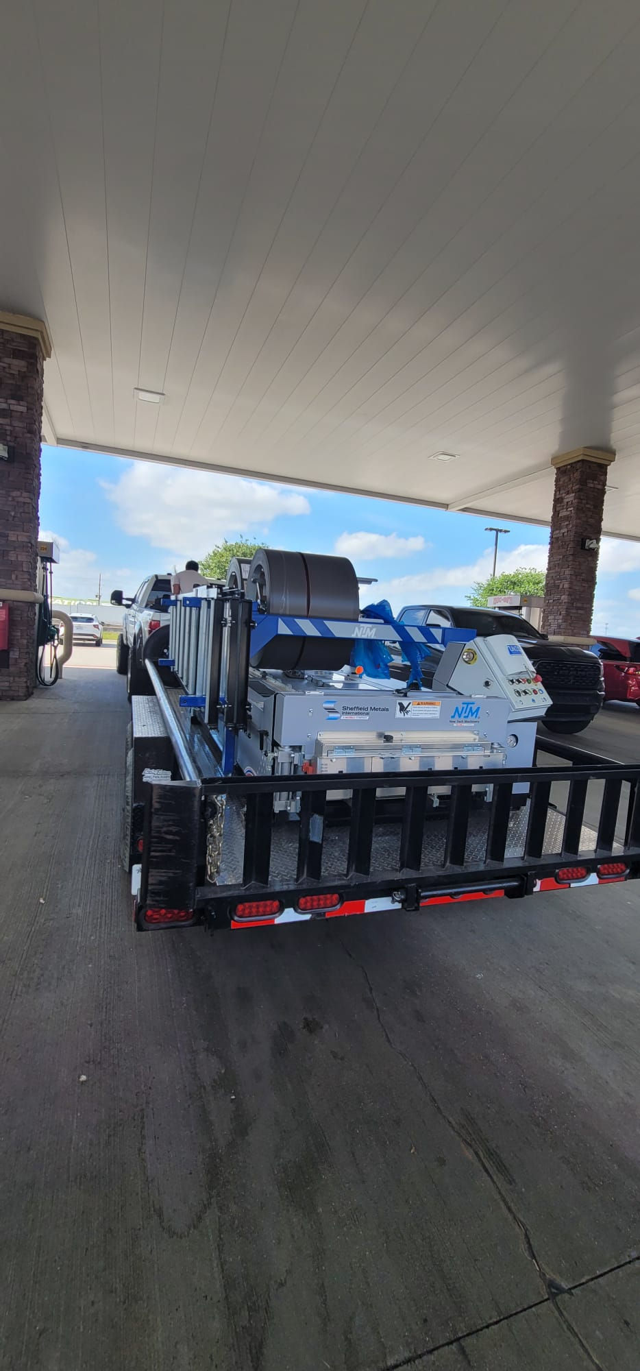 A portable metal roofing machine on a trailer