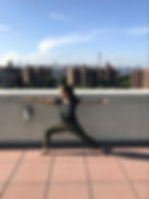 physical therapist with Zion Physical Therapy t-shirt demonstrating the warrior 2 pose