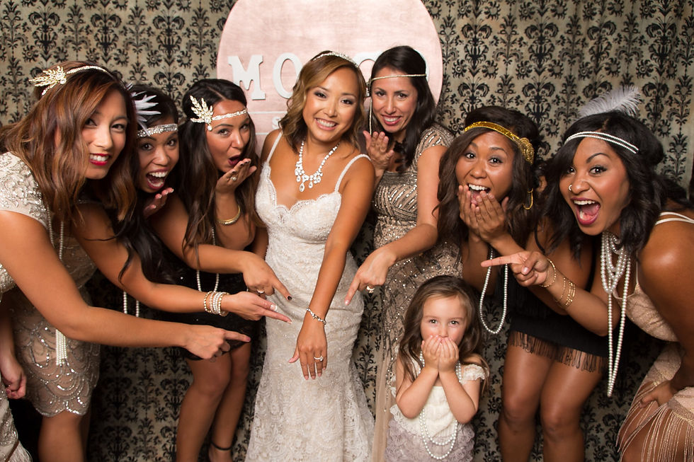 Bride taking pictures with brides maids with instabooth Rental