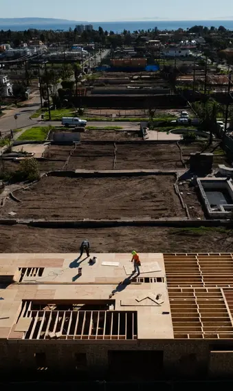 An aerial view shows houses being rebuilt on cleared lots months after the Palisades Fire, Dec. 5, 2025, in the Pacific Palisades neighborhood of Los Angeles. (AP Photo/Jae C. Hong)