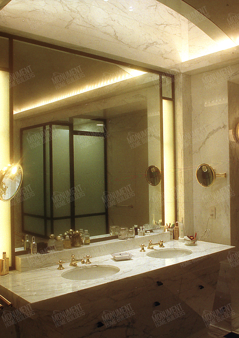 Summit Drive Residence | Monument Home Builders

Bathroom with mirror, lighting, and marble details

A luxurious, well-lit bathroom with a large mirror, marble walls, and elegant fixtures.