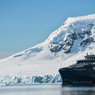 Antarctic expedition ship navigating near glacier — travel to Antarctica by sea
