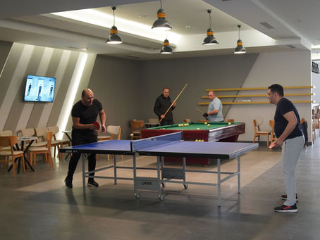 Games room with table tennis and billiards in use
