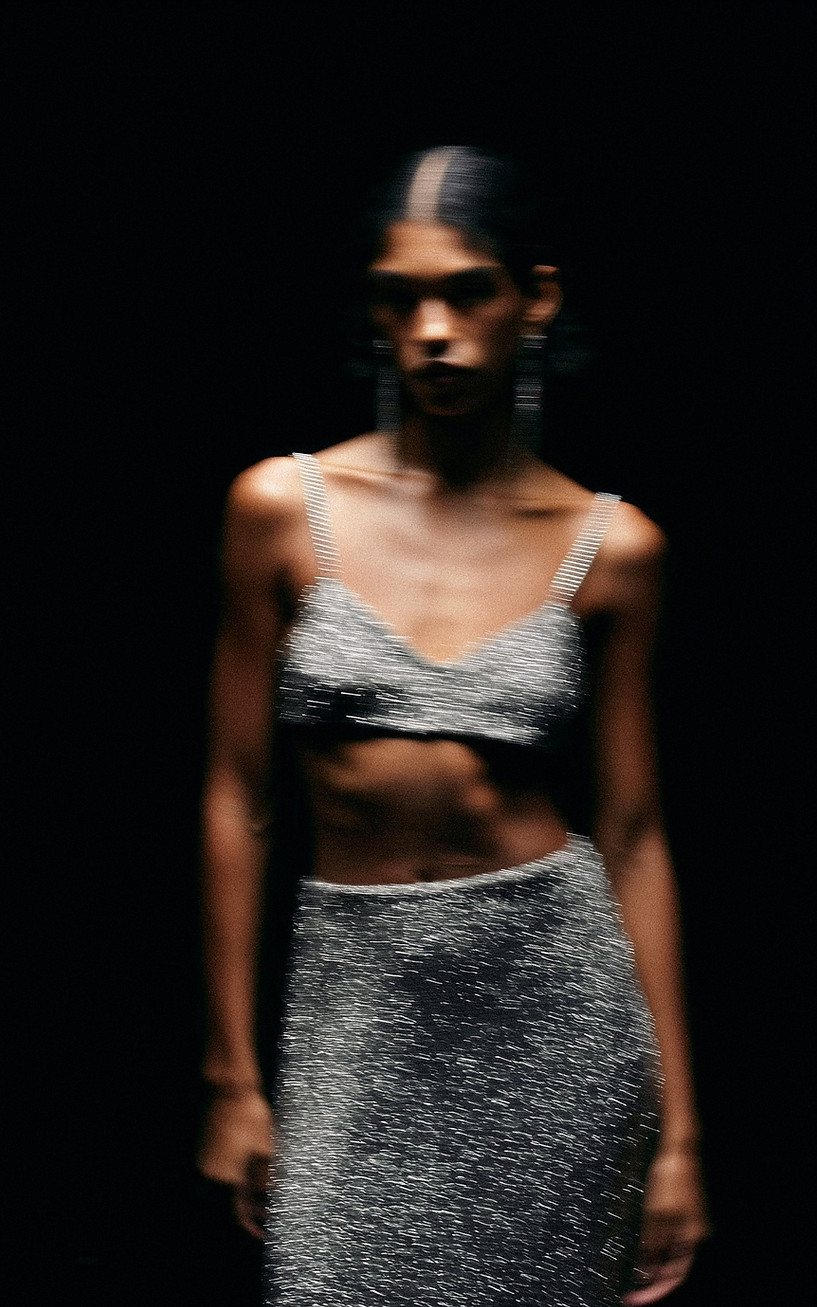Unhinged - Model in metallic crop top and skirt against dark backdrop - TVS.jpg