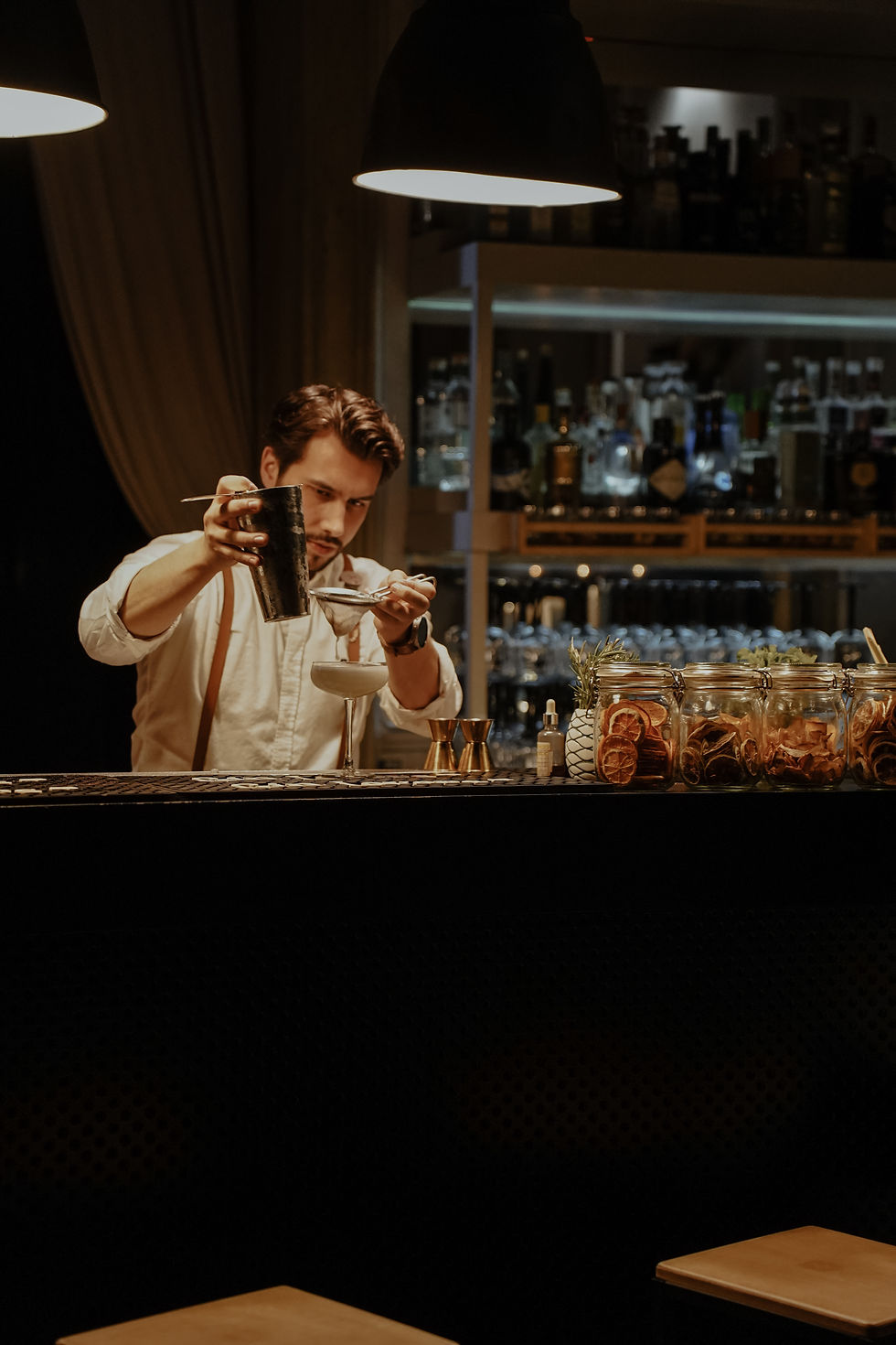 Apetite - Skilled bartender crafting cocktail with precise technique a - TVS.jpg