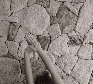 Flow - Person reaching upward against textured stone wall - TVS.jpg