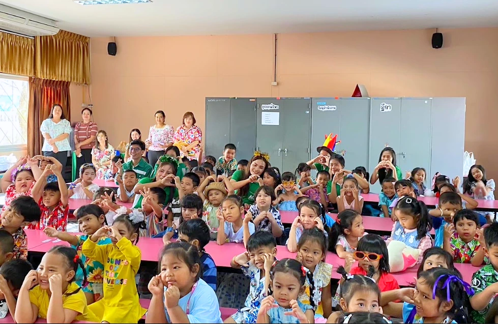 Employees and children taking part in a community activity