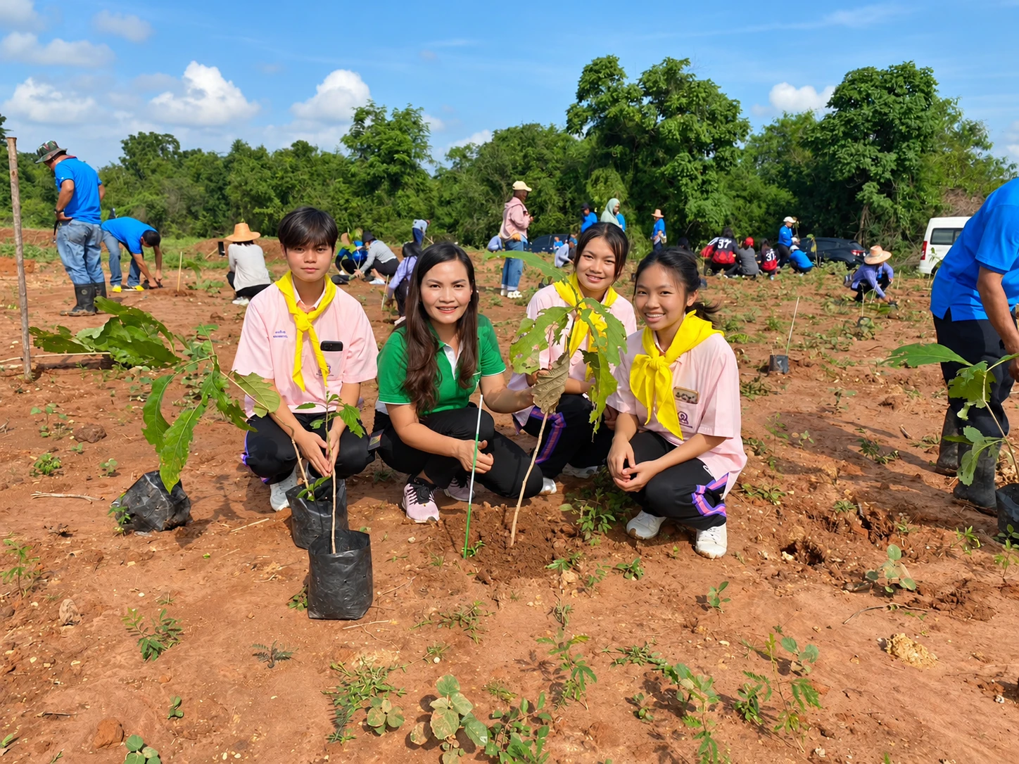 Students and community members planting trees together
