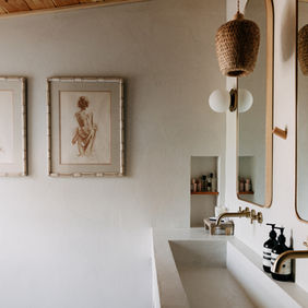 Vanity area with mirror, art, brass faucet and tub
Custom built-in sink with brass faucet and art — Royal Oak Michigan primary bathroom remodel by Costello & Co Construction