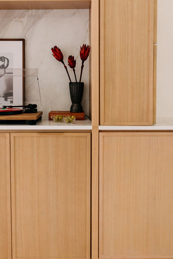 Light wood cabinets with marble-look quartz backsplash in Detroit home renovation